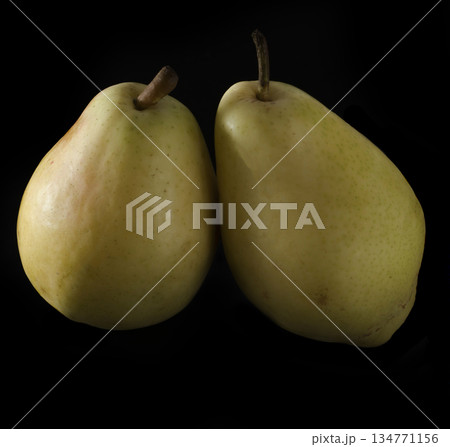 two ripe, juicy pears, on a black background two ripe, juicy pears, on a black background 134771156