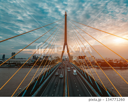symmetric modern cable-stayed Rama VIII bridge over Chao Phraya river in Bangkok, symmetry perspective of contemporary suspension urban span connecting city skyline across Thai waterway symmetric modern cable-stayed Rama VIII bridge over Chao Phraya river in Bangkok, symmetry perspective of contemporary suspension urban span connecting city skyline across Thai waterway 134771260