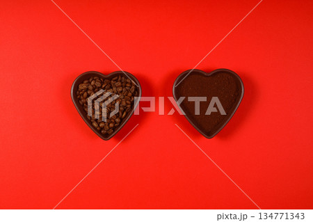 Heart coffee. Roasted coffee beans in the shape of heart on bright red background. Concept of coffee love, Valentines Day, 134771343