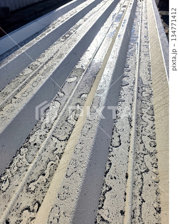 Corrugated Metal Sheet With Water Droplets on Surface Shines in Afternoon Sunlight Corrugated Metal Sheet With Water Droplets on Surface Shines in Afternoon Sunlight 134771412