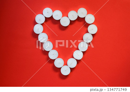 White candles in the shape of heart on Red background, concept of Valentine's Day 134771749