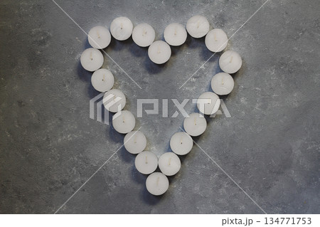 White candles in the shape of heart on stone background, concept of Valentine's Day 134771753