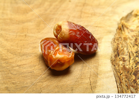 Dates on a stone background. Dried fruits. Dried dates lie next to each other 134772417