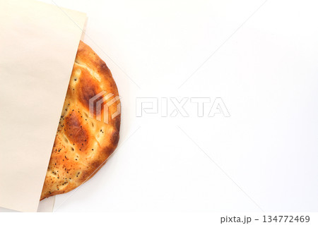 Slices of Ramadan Pita (Ramazan Pidesi) Traditional Turkish bread for holy month Ramadan on white background Slices of Ramadan Pita (Ramazan Pidesi) Traditional Turkish bread for holy month Ramadan on white background 134772469