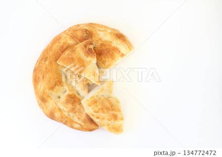 Slices of Ramadan Pita (Ramazan Pidesi) Traditional Turkish bread for holy month Ramadan on white background. Slices of Ramadan Pita (Ramazan Pidesi) Traditional Turkish bread for holy month Ramadan on white background. 134772472
