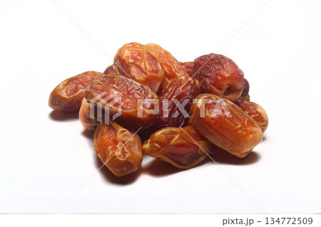 Dates on a white background. Dried fruits. Dried dates lie next to each other 134772509