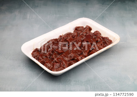 Cut raw beef liver with onions, spices, chili peppers and dill on wooden table, flat lay Cut raw beef liver with onions, spices, chili peppers and dill on wooden table, flat lay 134772590