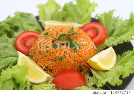 Traditional Turkish bulgur salad Kisir close-up on a plate on the table. Horizontal view from above 134772714