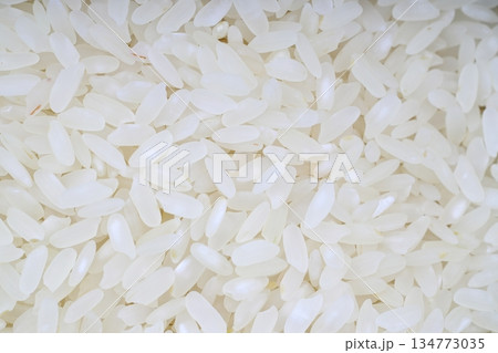 Top view of polished long raw rice background. Organic, natural white rice seed texture. Rice 's grains Top view of polished long raw rice background. Organic, natural white rice seed texture. Rice 's grains 134773035