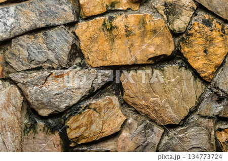 The wall is made of many small stones 134773724