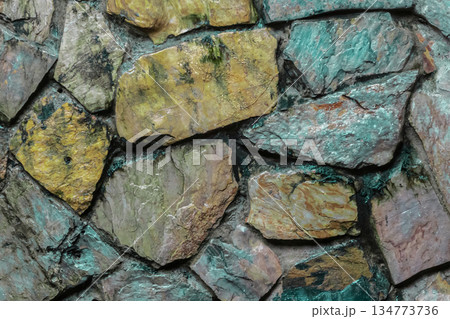 A wall made of stone with a brown and gray color A wall made of stone with a brown and gray color 134773736