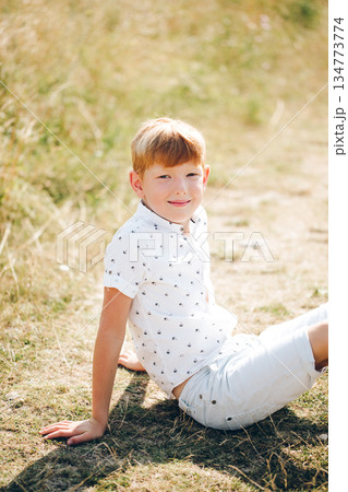 Outdoor family moment with mother and sons in a sunny field for campaigns and storytelling 134773774