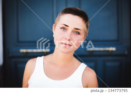 Young woman with buzz cut and blue eyes 134773795