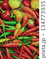 The peppers are of different sizes and colors, creating a vibrant and colorful display. Concept of abundance and variety 134773935