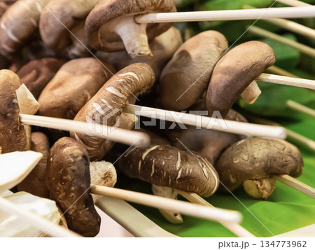 assorted mushroom skewers and vegetables on wooden skewers selective focus 134773962