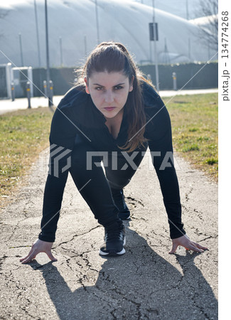 Woman with visual disabilities exercising in the park and stretching Woman with visual disabilities exercising in the park and stretching 134774268