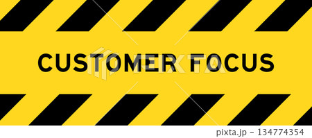 Yellow and black color with line striped label banner with word customer focus 134774354