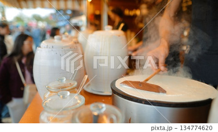Dynamic kitchen moment showing spinning steam and sizzling spatula action 134774620