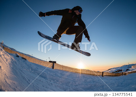 Snowboarding in the mountains Snowboarding in the mountains 134775541