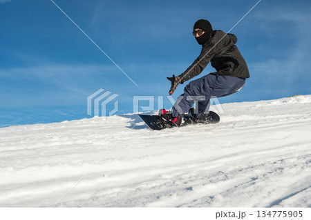 Snowboard freerider in the mountains 134775905