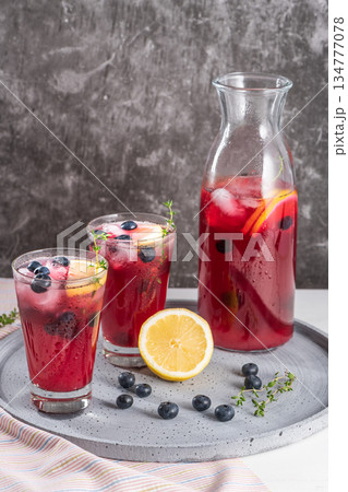 Fresh blueberry summer mojito cocktail. Blueberry lemonade or sangria on kitchen countertop. 134777078
