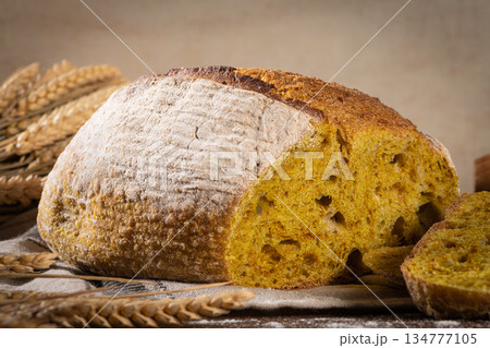 Freshly artisan baked wheat, turmeric and rye bread, country bread. Simple bread for breakfast Freshly artisan baked wheat, turmeric and rye bread, country bread. Simple bread for breakfast 134777105