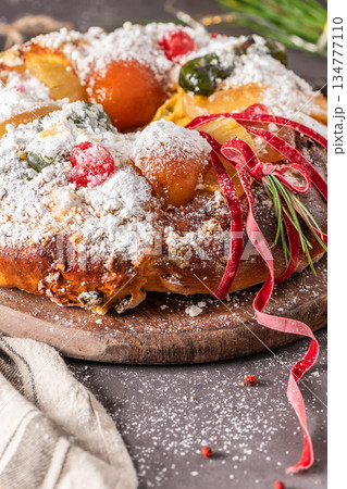Bolo do Rei or King s Cake, Made for Christmas, Carnavale or Mardi Gras with Christmas season elements in Background. Bolo do Rei or King s Cake, Made for Christmas, Carnavale or Mardi Gras with Christmas season elements in Background. 134777110