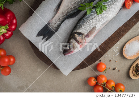 Fresh fish sea bass on wooden table. 134777237