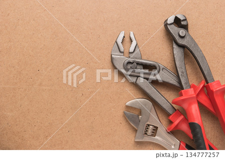 Set of pump plier, plier and wrenches. Tools over a wood panel. Top view with copy space. Set of pump plier, plier and wrenches. Tools over a wood panel. Top view with copy space. 134777257
