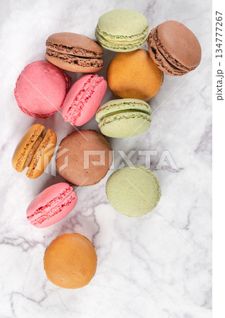 Colorful macaroons on marble background. Sweet macarons. Top view with copy space for your text Colorful macaroons on marble background. Sweet macarons. Top view with copy space for your text 134777267