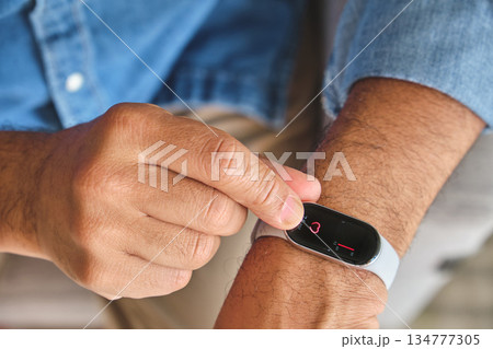 Man monitoring heart rate with fitness tracker on wrist Man monitoring heart rate with fitness tracker on wrist 134777305
