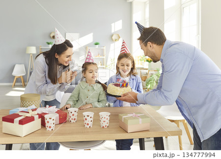 Happy Family Celebrating Birthday With Cake And Gifts At Home Happy Family Celebrating Birthday With Cake And Gifts At Home 134777994