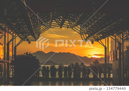 Oct 1 2025 Sunset Silhouettes On A Modern Rooftop Pier As People Oct 1 2025 Sunset Silhouettes On A Modern Rooftop Pier As People 134779440