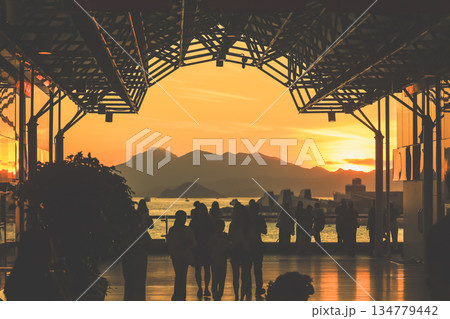 Oct 1 2025 Sunset Silhouettes On A Modern Rooftop Pier As People Oct 1 2025 Sunset Silhouettes On A Modern Rooftop Pier As People 134779442
