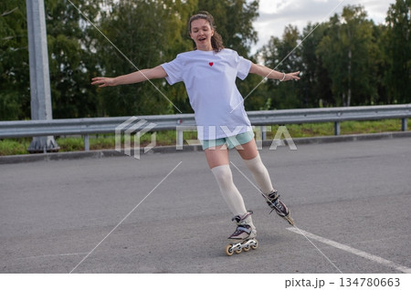 Caucasian woman in shorts roller skating.  134780663