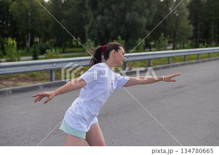 Caucasian woman in shorts roller skating.  134780665