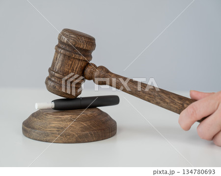 Judge's gavel and electronic cigarette. Tobacco heating system.  134780693