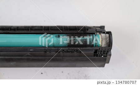 Broken laser printer cartridge on white background. Broken laser printer cartridge on white background. 134780707