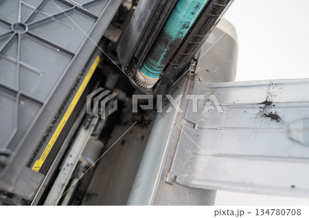 Broken laser printer cartridge on white background. Broken laser printer cartridge on white background. 134780708