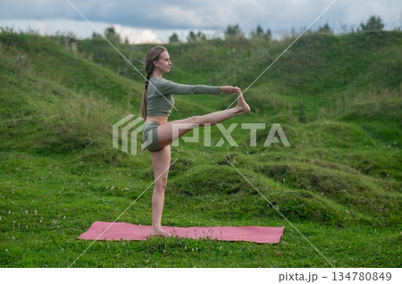 Caucasian woman doing yoga outdoors.  134780849