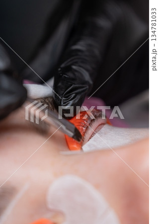 Caucasian woman undergoing eyelash lamination procedure.  134781033