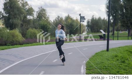 Caucasian woman roller skating in park. Caucasian woman roller skating in park. 134781046