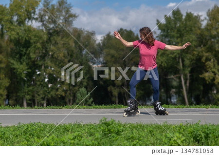 Caucasian woman roller skating in park.  134781058