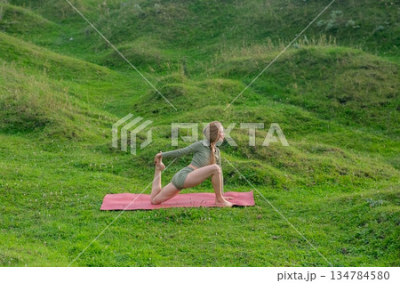 Caucasian woman doing yoga outdoors.  134784580