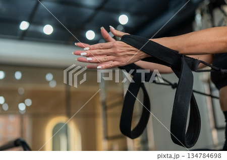 Caucasian woman doing exercises on reformer machine.  134784698