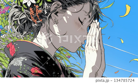 手を合わせてお祈りをしている和服姿の若い女性