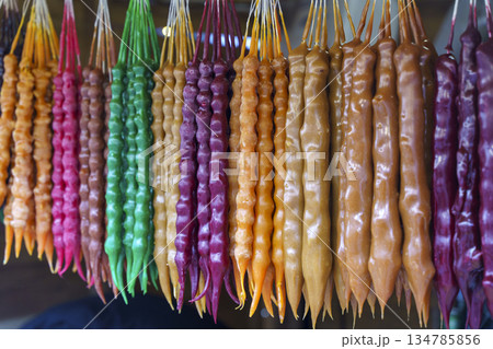 Traditional Georgian Churchkhela Sweets Hanging in a Row at a Market. High quality photo 134785856