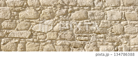 Stone wall texture closeup showing old rugged masonry Stone wall texture closeup showing old rugged masonry 134786388