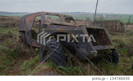 rusty armored vehicle stranded in meadow, large heavy tire half-buried in mud, open engine bay, peeling paint, rusty armored vehicle stranded in meadow, large heavy tire half-buried in mud, open engine bay, peeling paint, 134786830