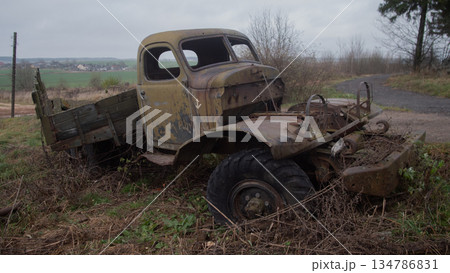 rusty pickup truck abandoned in field, weathered cab missing hood, platform overtaken by weeds, damp grass, rusty pickup truck abandoned in field, weathered cab missing hood, platform overtaken by weeds, damp grass, 134786831